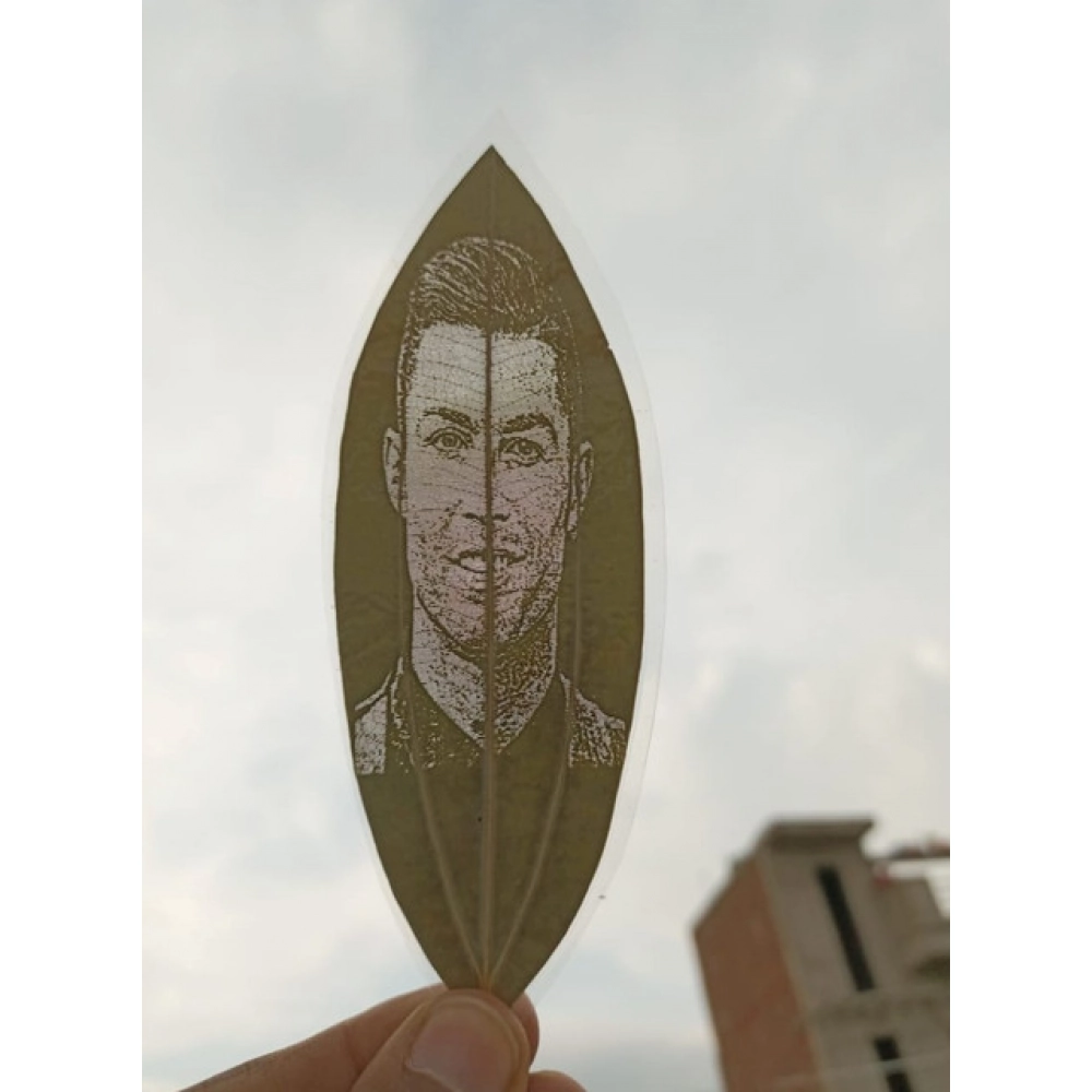 64016-1000x1000-1.webp Custom Engraved Leaf Art – Football Icon Portrait on Natural Lea - Image 1